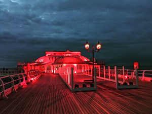 Cromer Pier glows in support of the ‘Light It In Red’ campaign