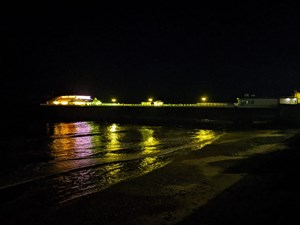 Cromer Pier lit in yellow in support of Marie Curie's National Day of Reflection