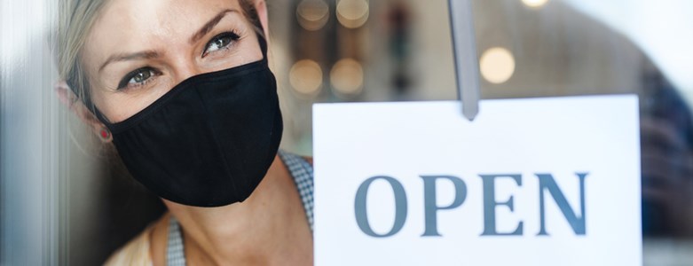 women in mask open sign.jpg