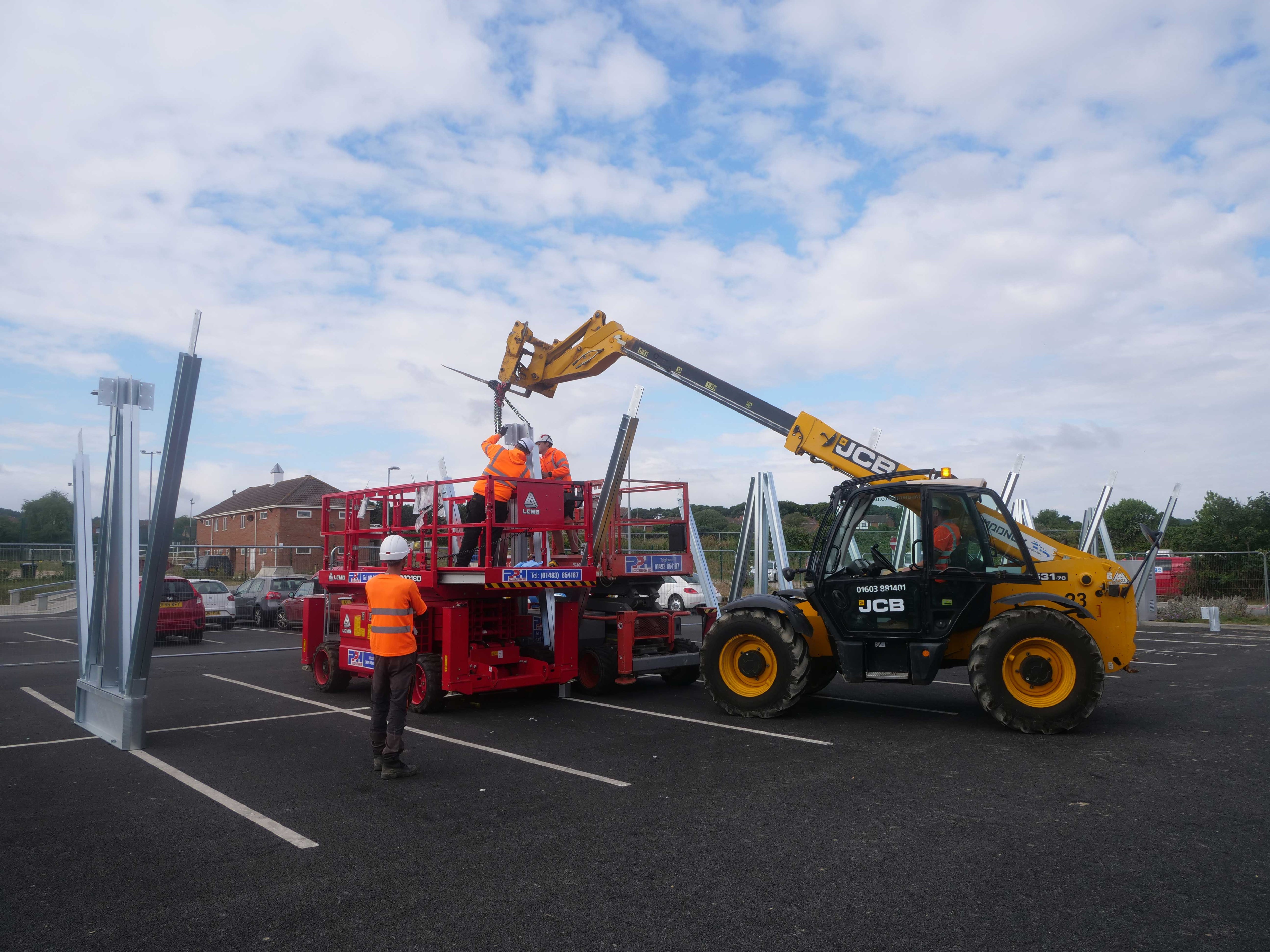 Construction workers on site at The Reef assembling solar carport