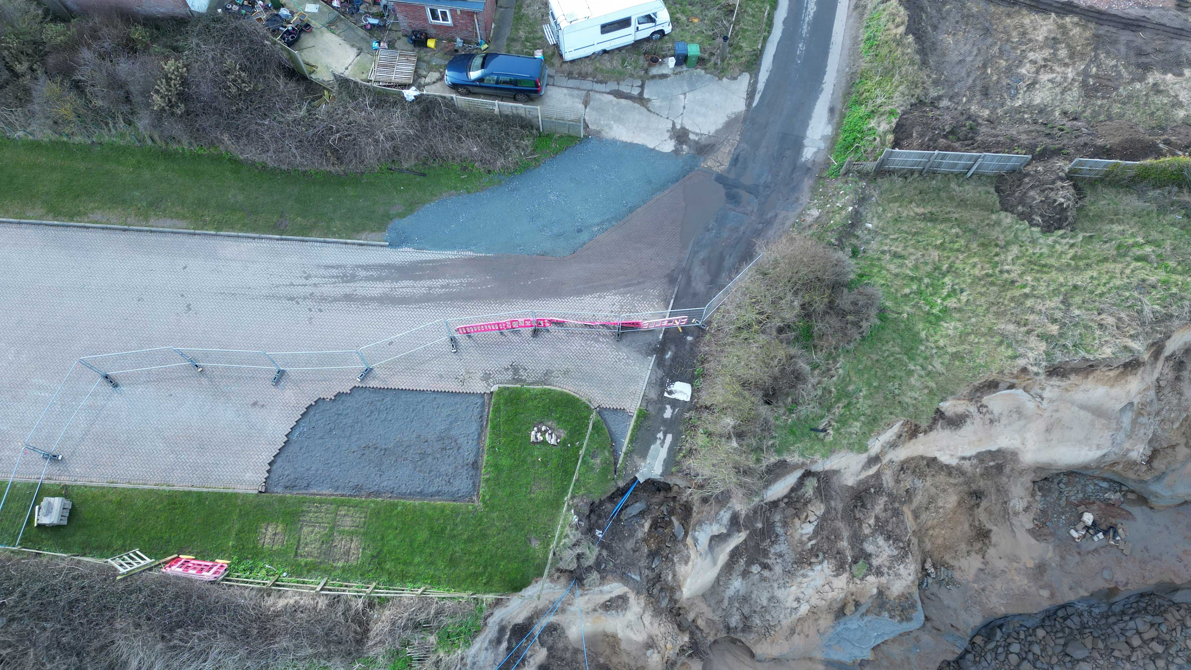 Beach Road at Happisburgh, showing the road has been redirected through the neighbouring property exterior garden.